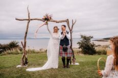 gullane beach wedding ceremony driftwood archway grace loves lace preloved wedding dress