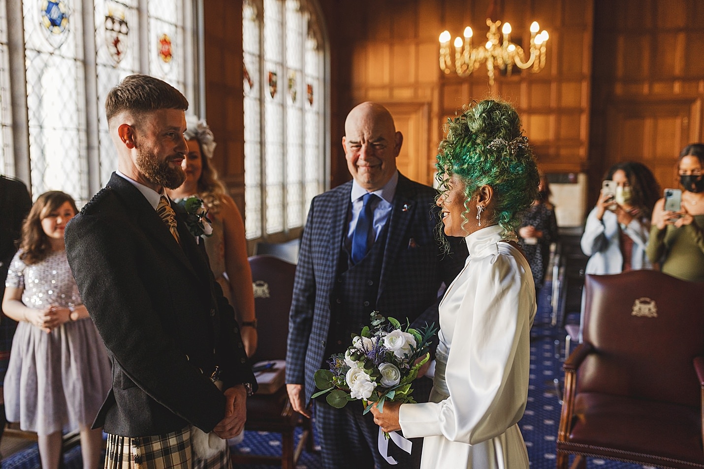 bride and groom smiling at each other as they stand ready for ceremony marischal college wedding clarke joss photography
