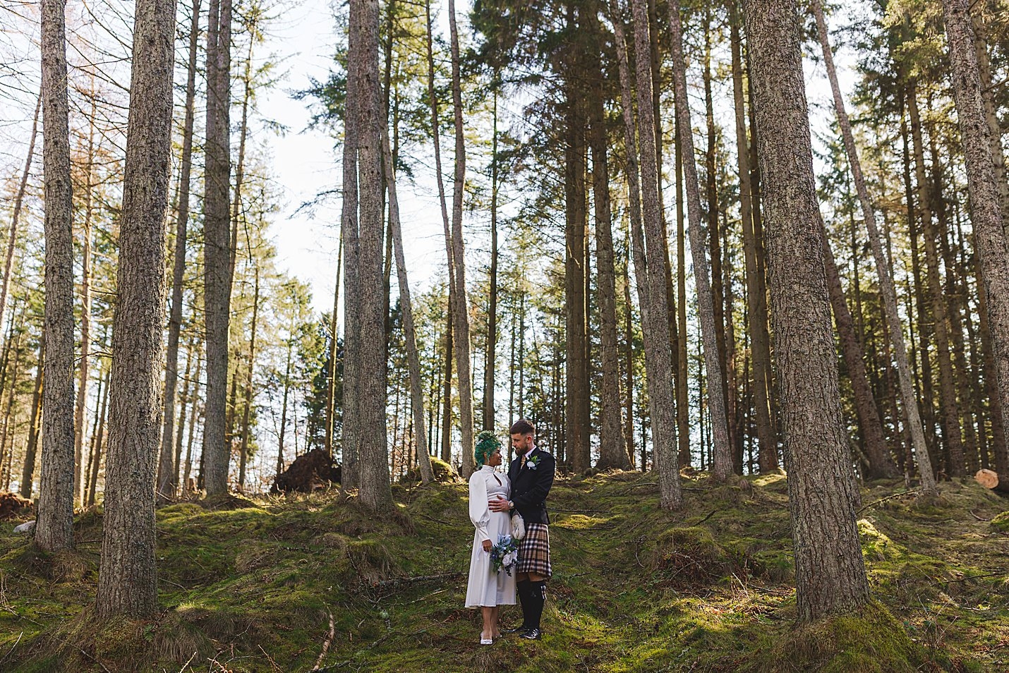 bride and groom standing in forest looking into each others eyes marischal college wedding clarke joss photography