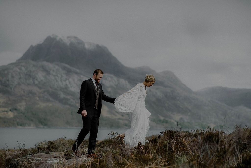 Couple elope to Scotland and are married by a loch, surrounded by mountains