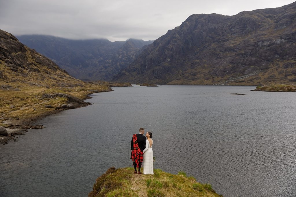 Bride and groom look out over Loch Coruisk at their Isle of Skye wedding