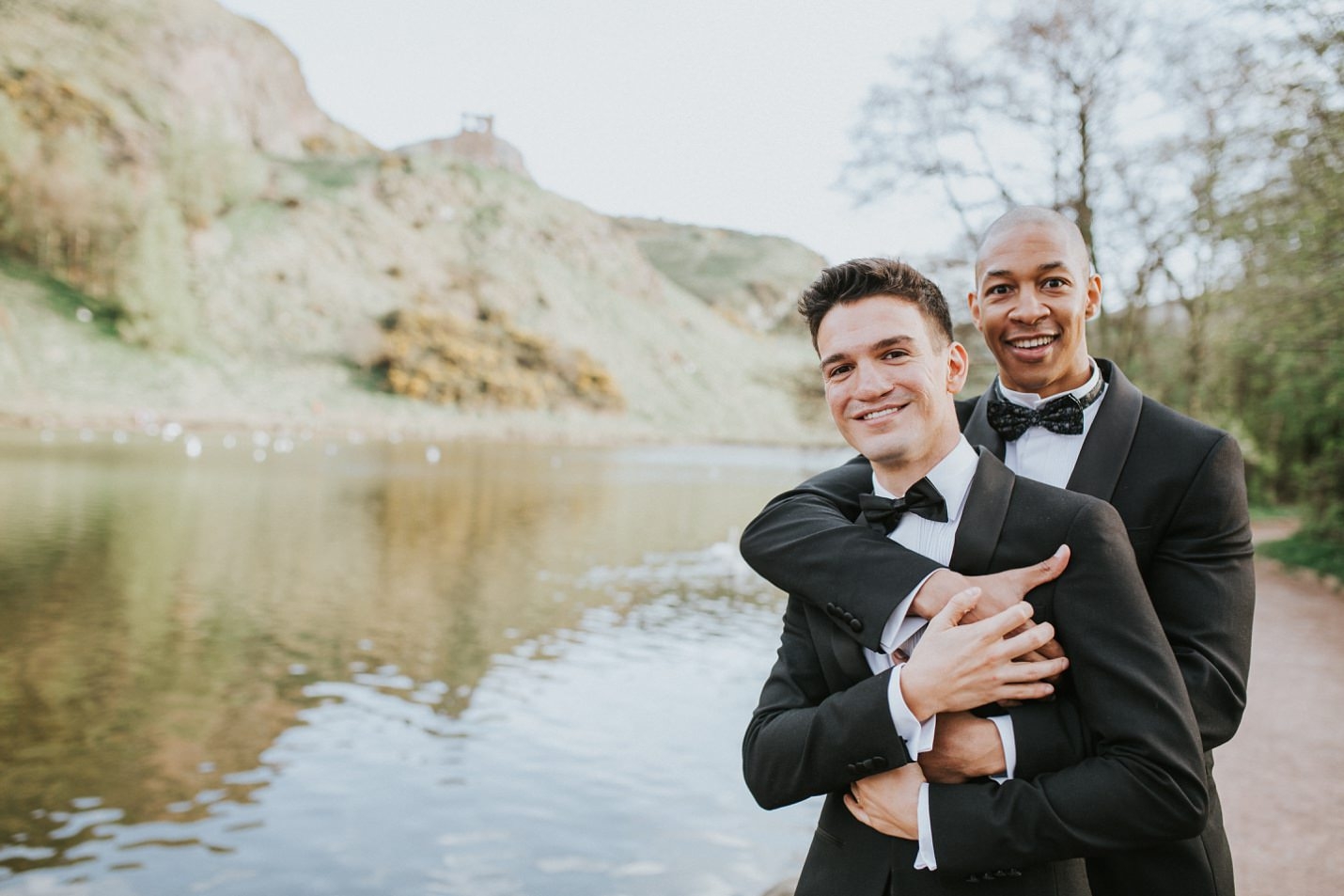 holyrood park pond edinburgh micro wedding two grooms cuddling