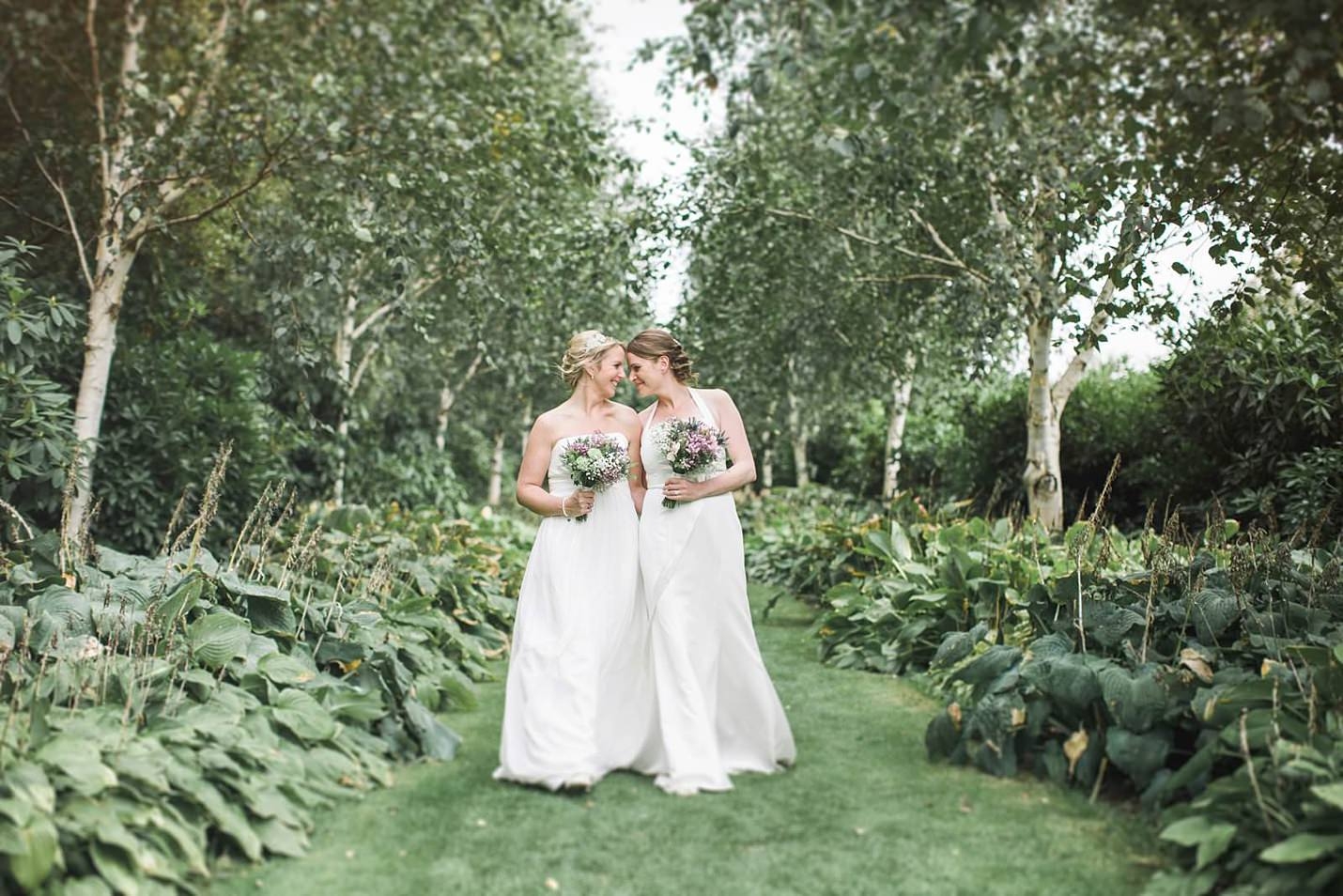 two brides walking down woodland path Wedding Photographer Scotland The Gibsons