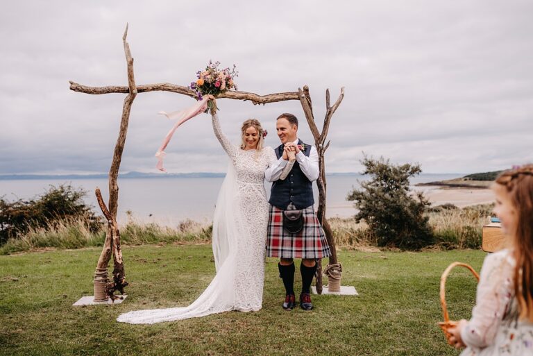 gullane beach wedding ceremony driftwood archway grace loves lace preloved wedding dress