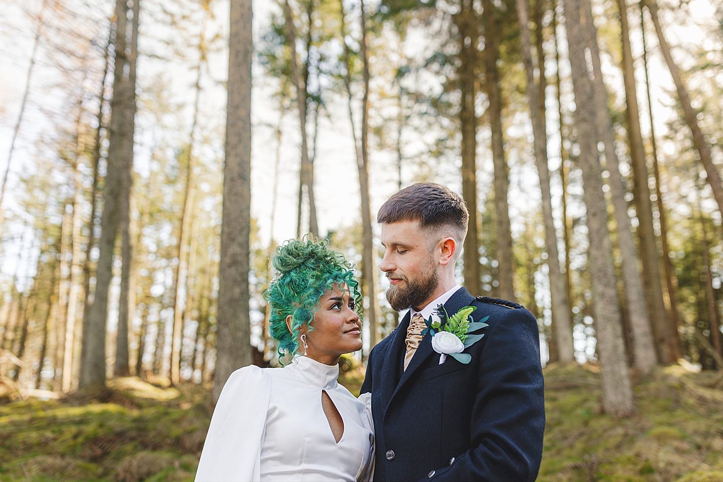 close up of bride and groom looking lovingly into each others eyes as thy stand in forest marischal college wedding clarke joss photography