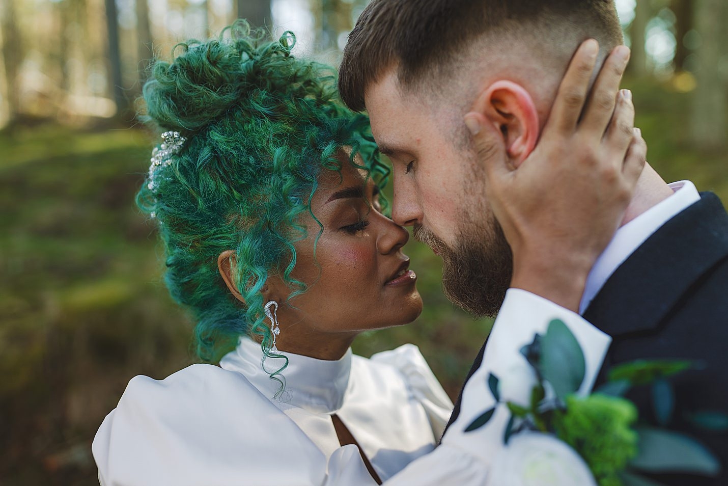 bride with eyes closed holding back of grooms neck as they touch noses in forest marischal college wedding clarke joss photography